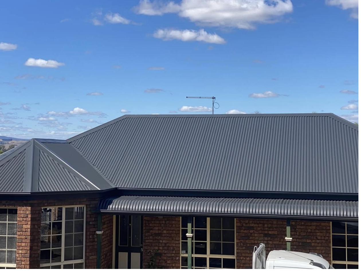 Same roof in Monument Colorbond after respray